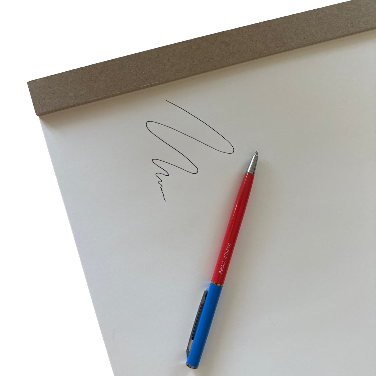 Red and blue pen on a white sheet of paper with wavy lines.