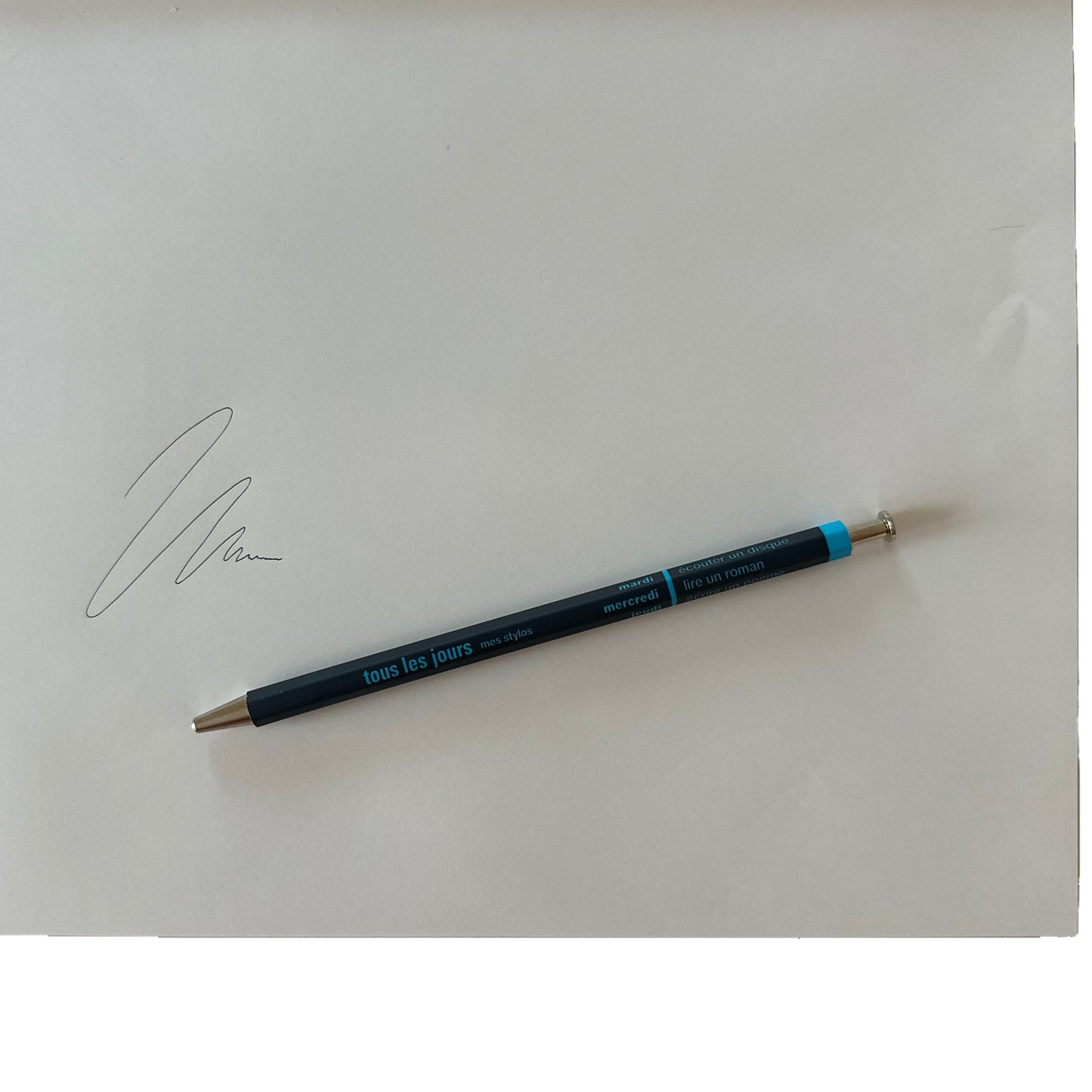 Navy pen on a white background with a signature