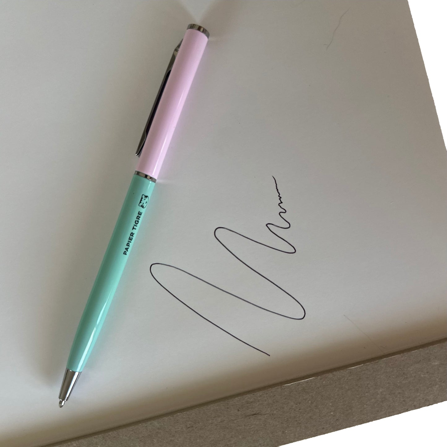 Pink and green pen on paper with ink drawing