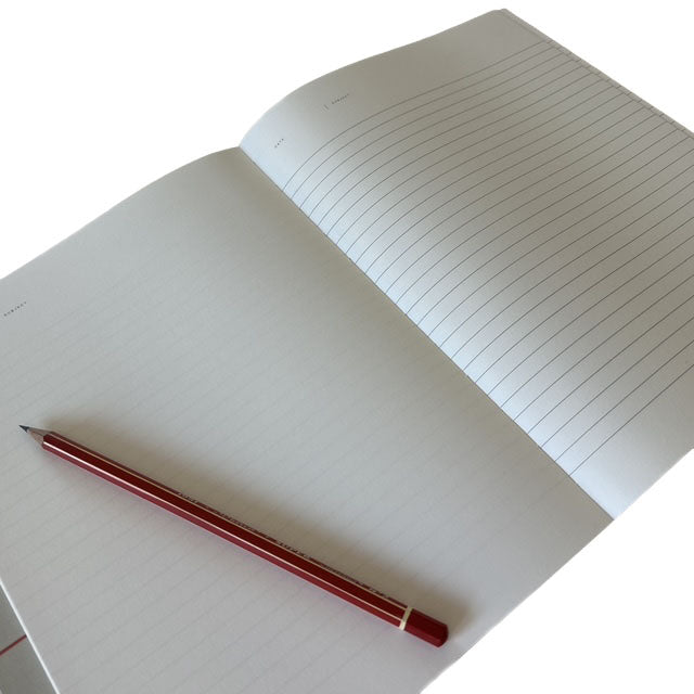 Open notebook with a red pencil on a white background