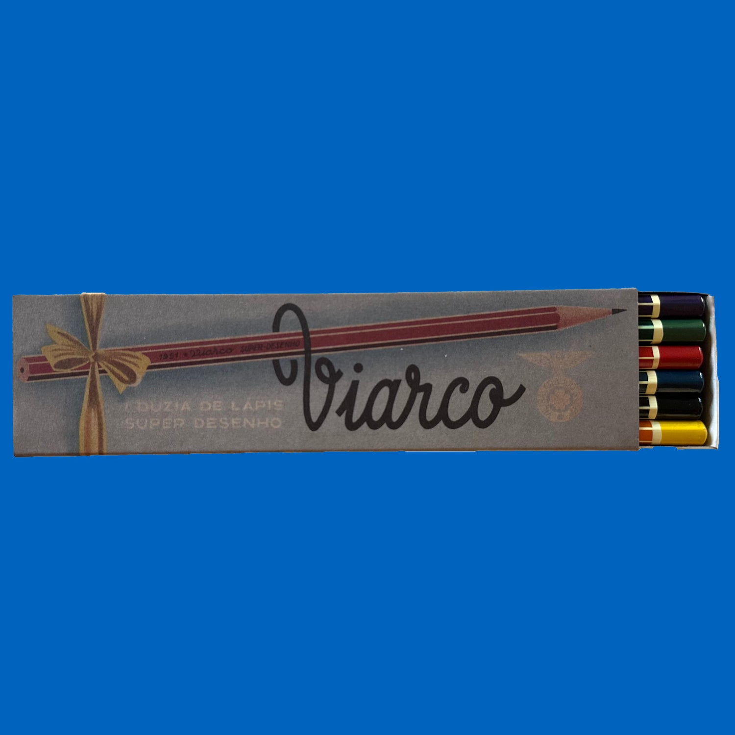 Box of Viarco drawing pencils with colored tips on a blue background