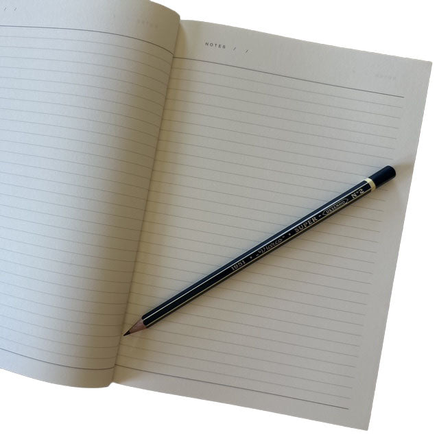 Open notebook with a blue pencil on a white background