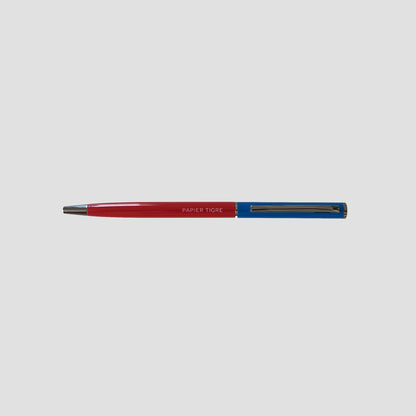 Pen with red and blue accents on a light gray background