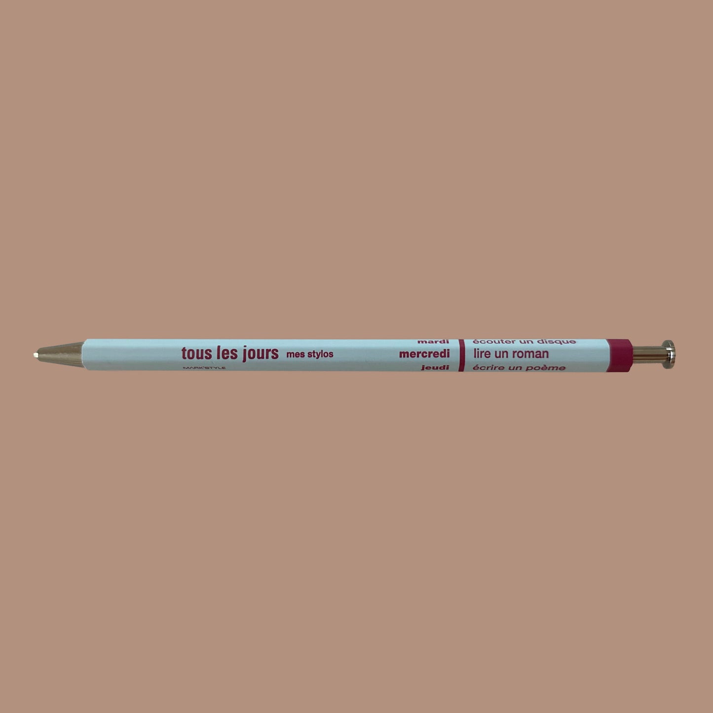 Light blue pen against beige background