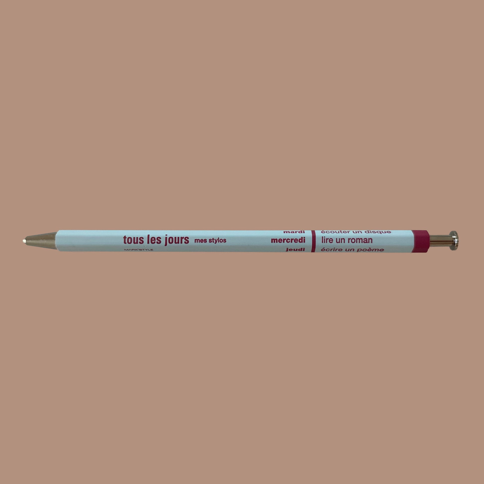 Light blue pen against beige background