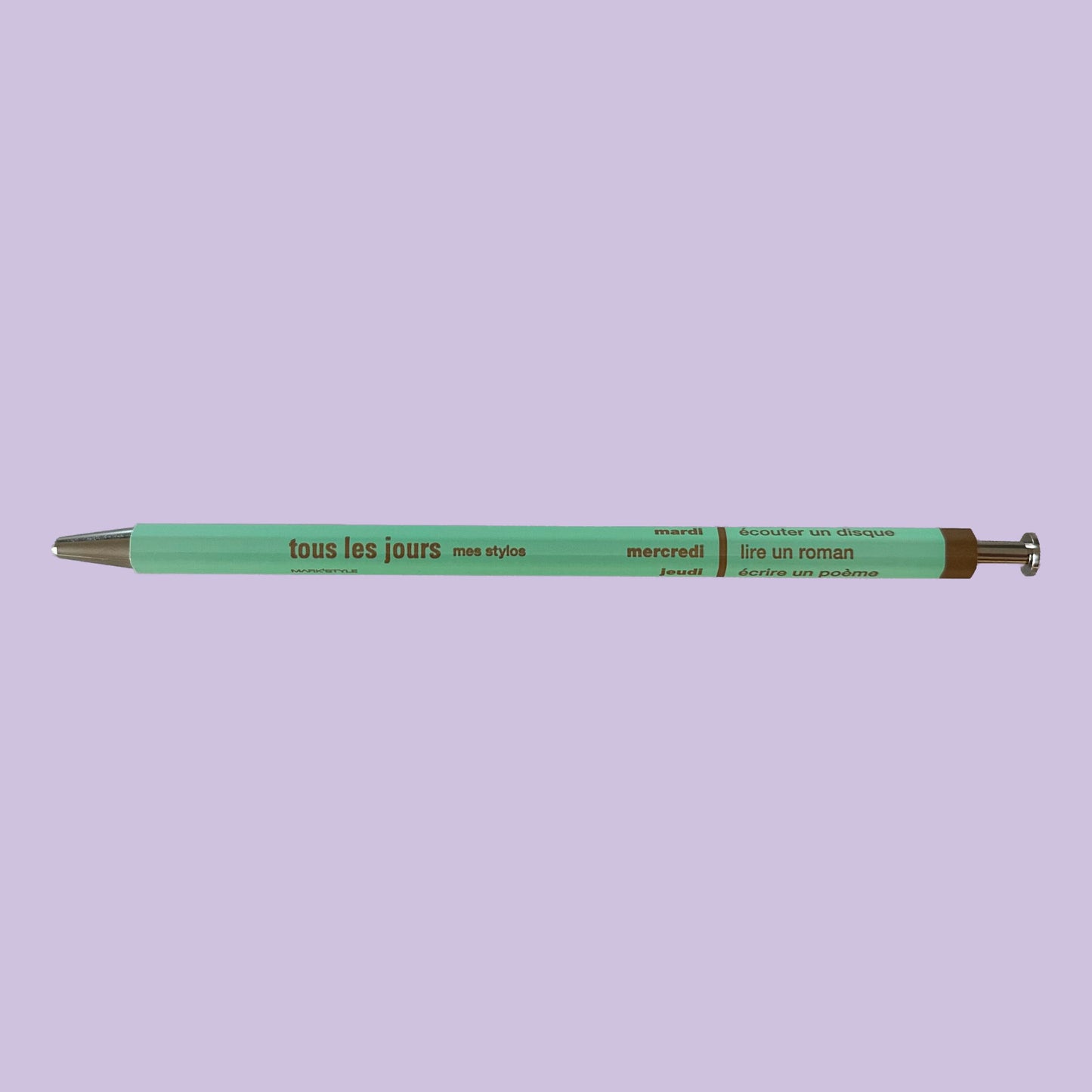 Light mint pen against lavender background
