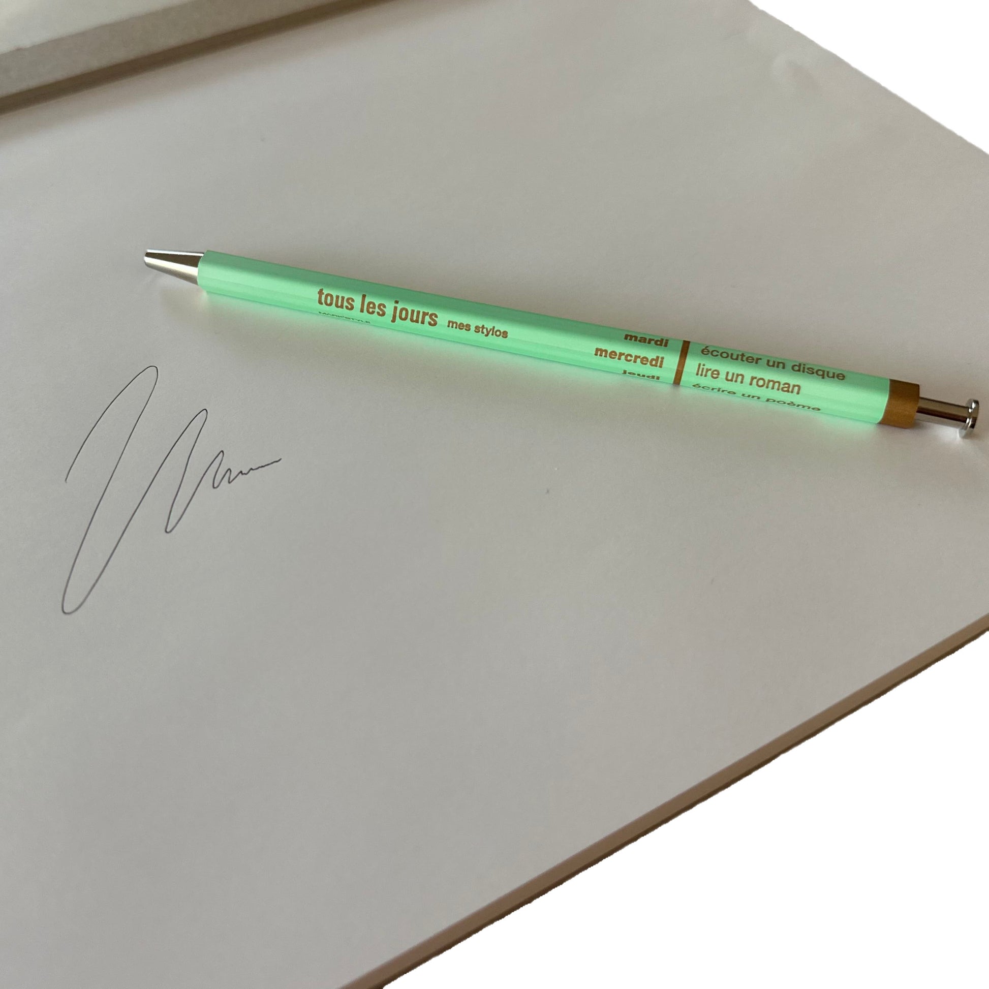 Mint pen with text on a white surface