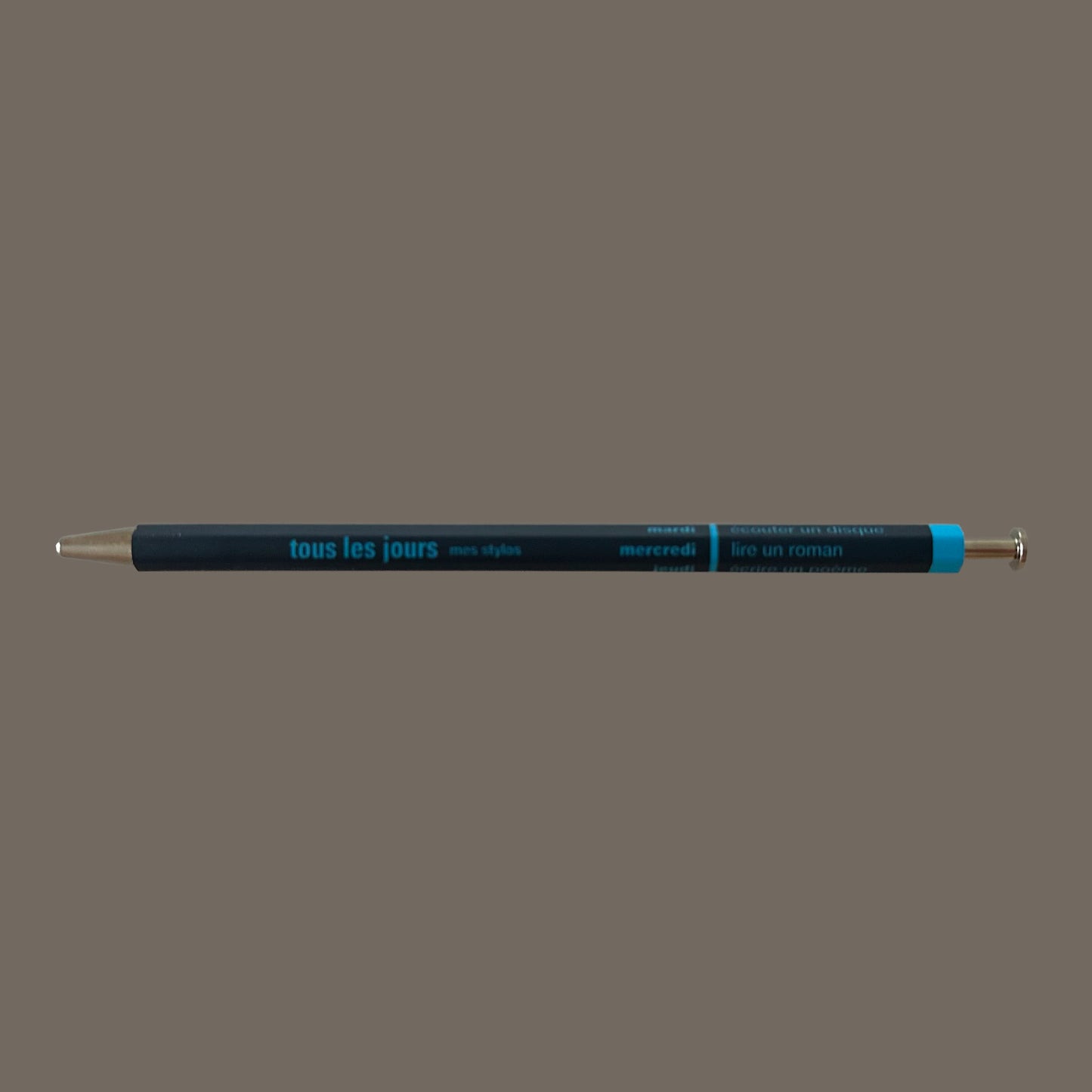 Navy pen against grey background.