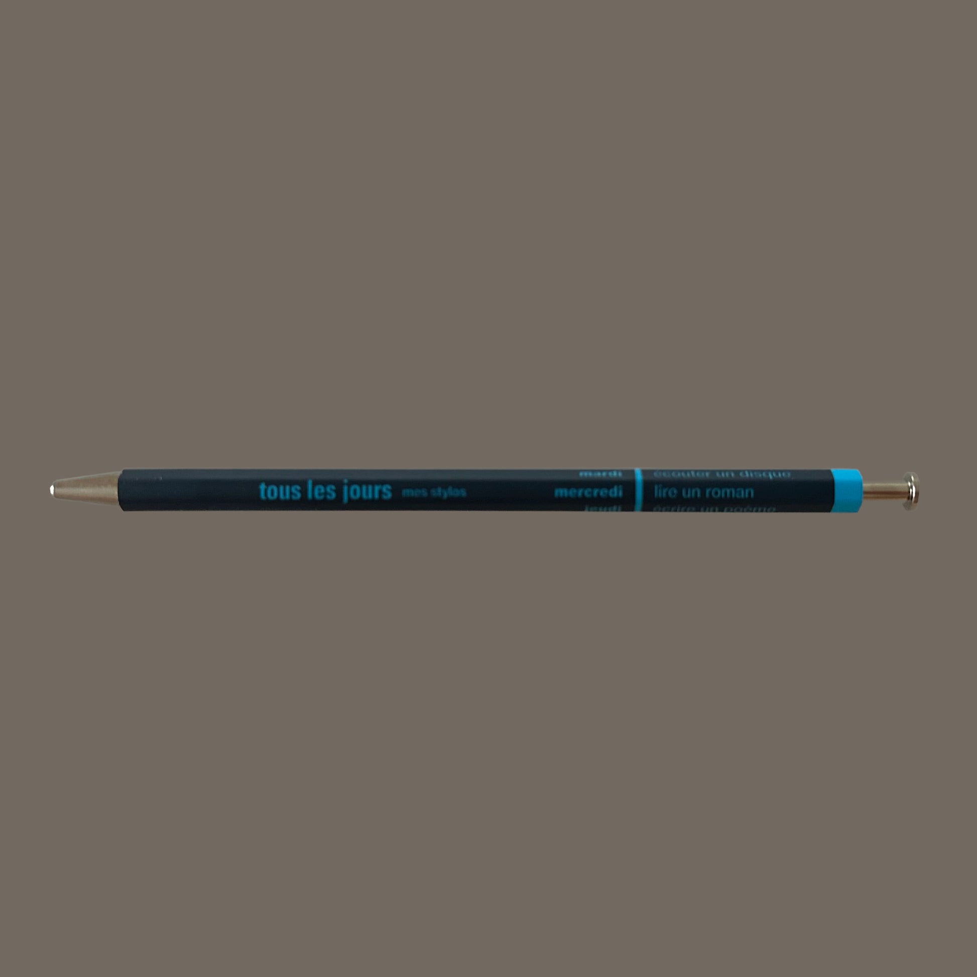 Navy pen against grey background.