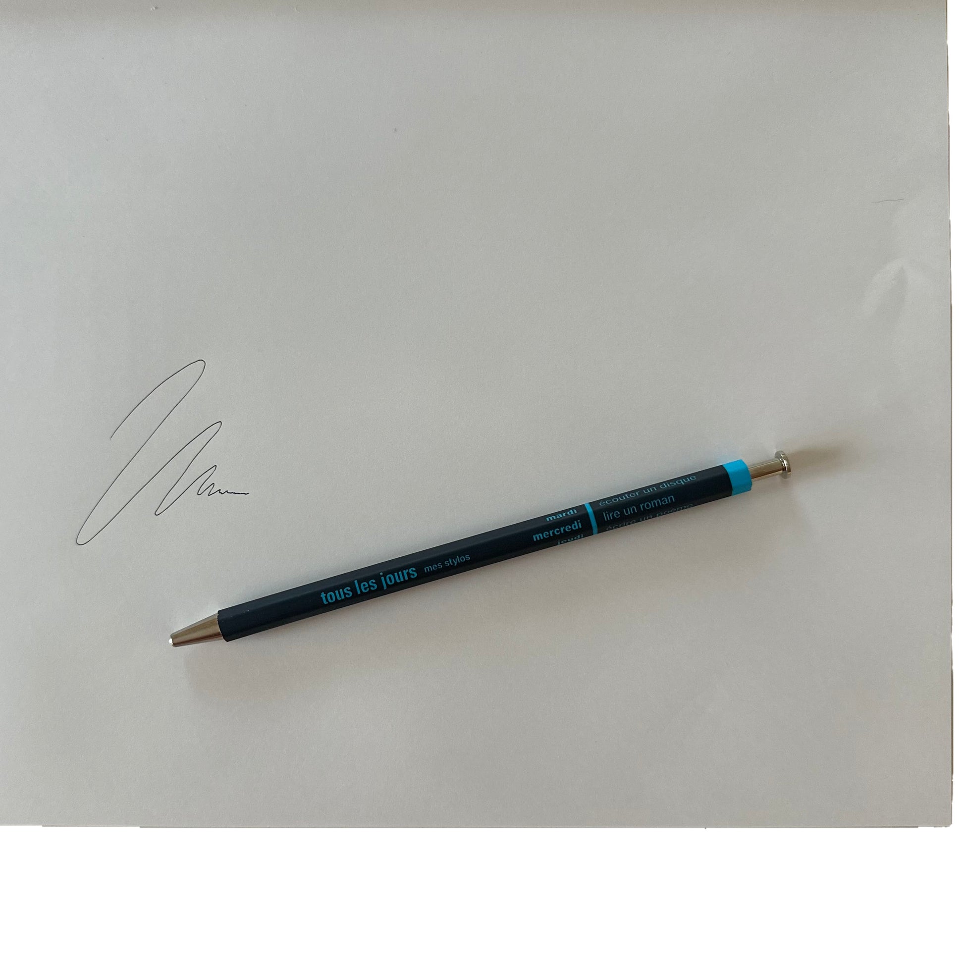 Navy pen on a white background with a signature