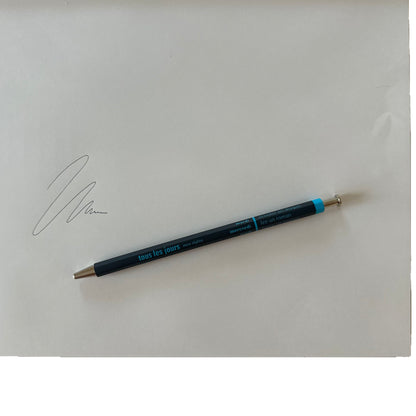 Navy pen on a white background with a signature