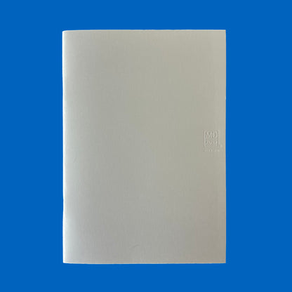 Beige notebook with MD logo on a blue background