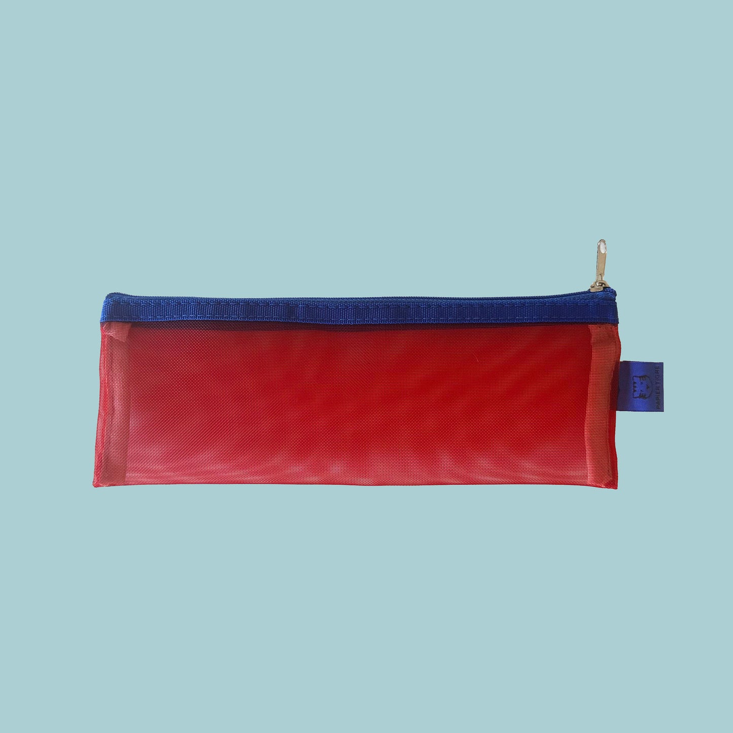 Red pencil case with blue zipper on a light blue background