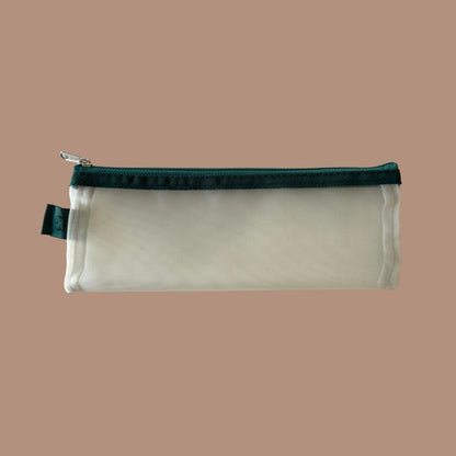 Yellow pencil case with green zipper on a beige background