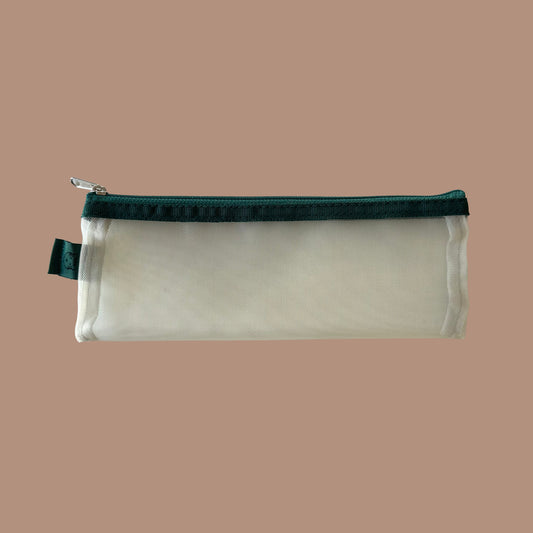 Yellow pencil case with green zipper on a beige background