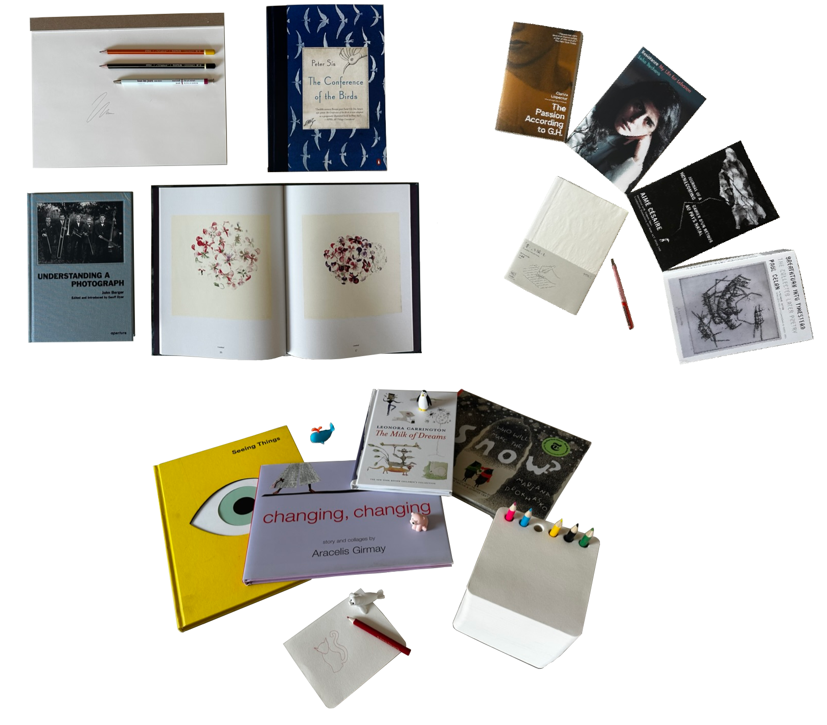 Collection of books, notebooks, and stationery items on a white background