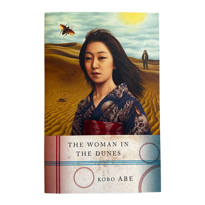Book cover of 'The Woman in the Dunes' by Kobo Abe with a desert scene and woman in kimono.