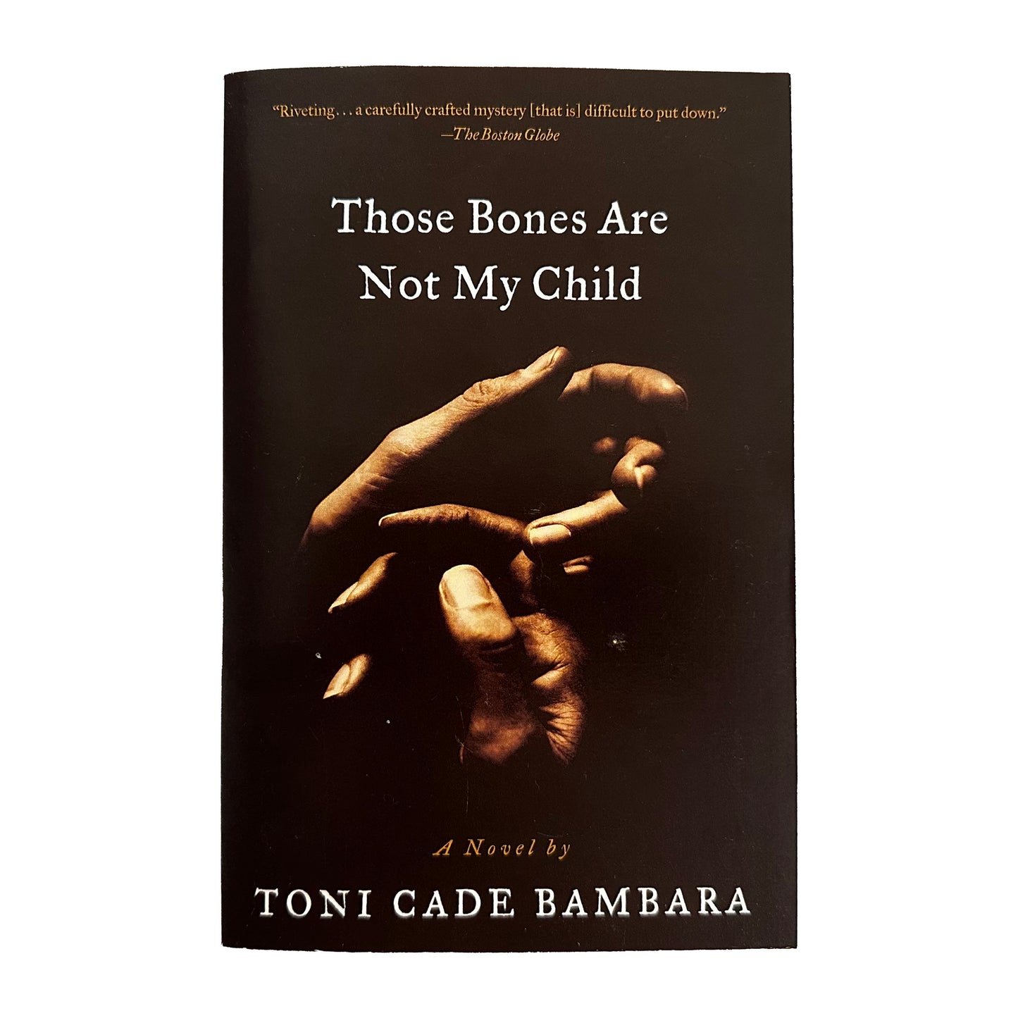 Book cover of 'Those Bones Are Not My Child' by Toni Cade Bambara with a dark background and hands holding each other.
