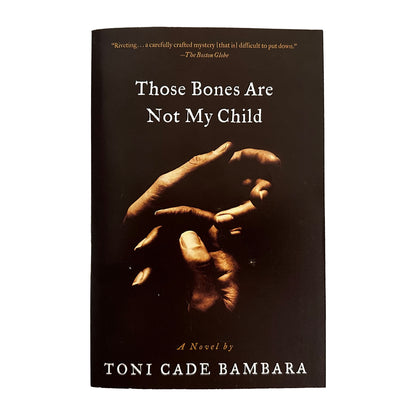 Book cover of 'Those Bones Are Not My Child' by Toni Cade Bambara with a dark background and hands holding each other.