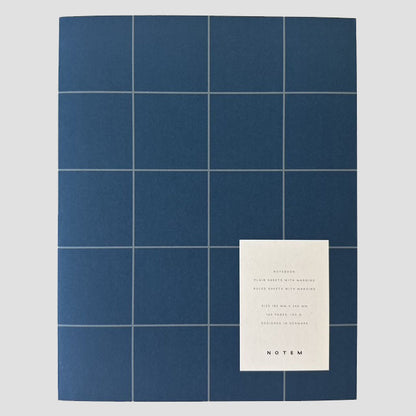 Blue grid patterned notebook with text on a gray background