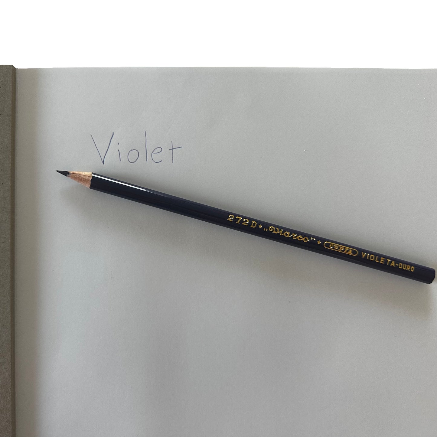 Pencil labeled 'Violet' on a white surface