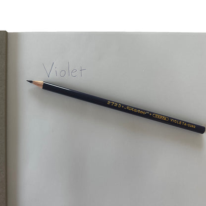 Pencil labeled 'Violet' on a white surface