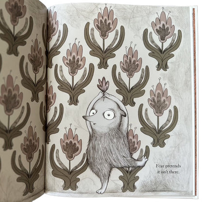 Illustration of a creature among floral patterns with text 'Fear pretends it isn't there.'